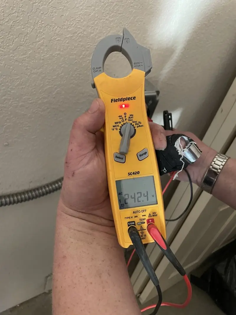 Voltage testing with clamp meter during Recessed Lighting Installation in Central